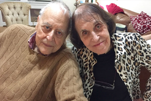 elderly couple smiling at the camera