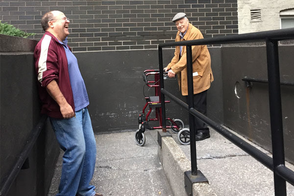 two men walking up a ramp and laughing